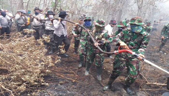 Hujan buatan padamkan seluruh titik panas di Riau, Petugas TNI dan Polri bersama tim gabungan memadamkan kebakaran hutan dan lahan di wilayah Riau dengan alat pemadam sederhana di tengah asap tebal.